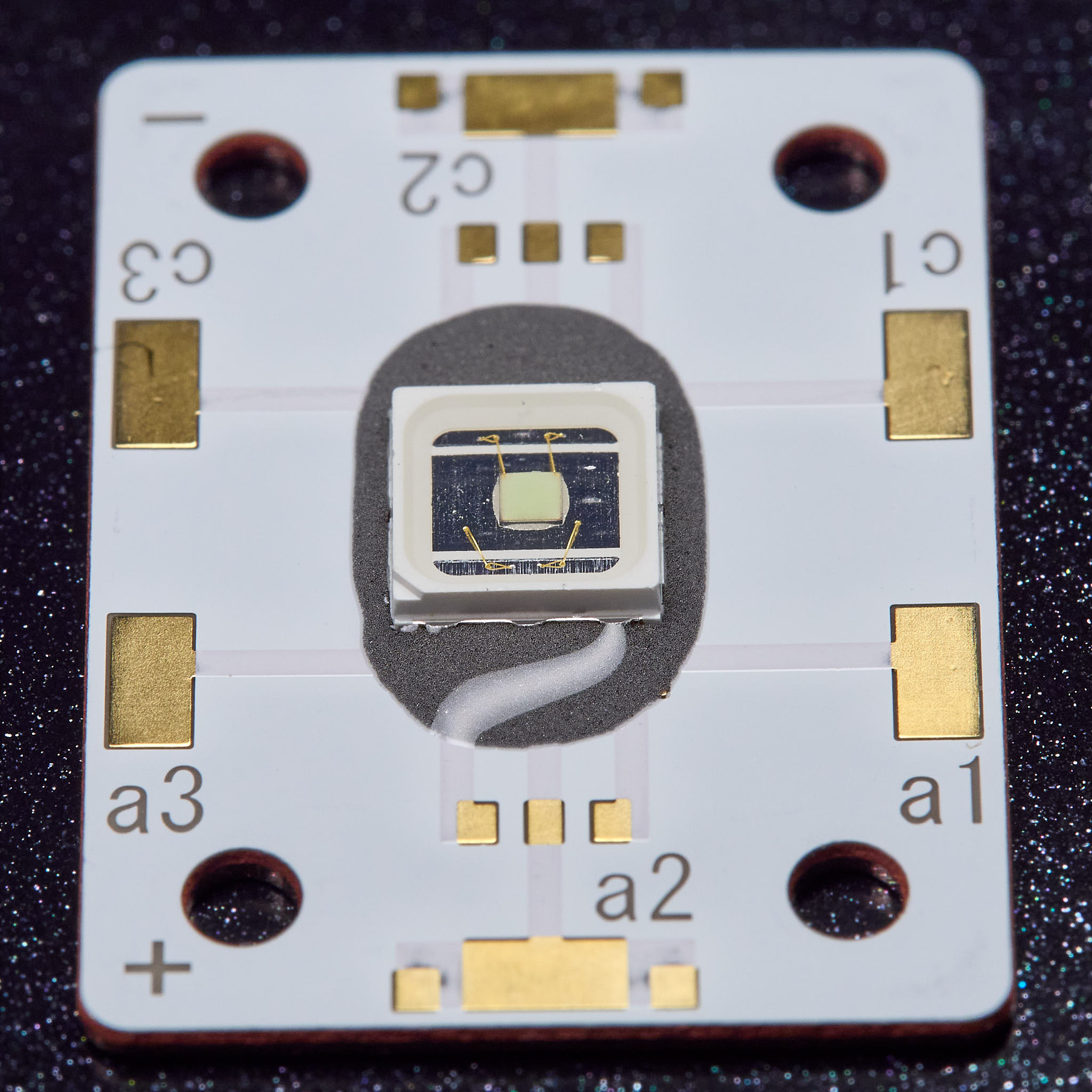 The LED sitting on the solder paste (hot and spreading)