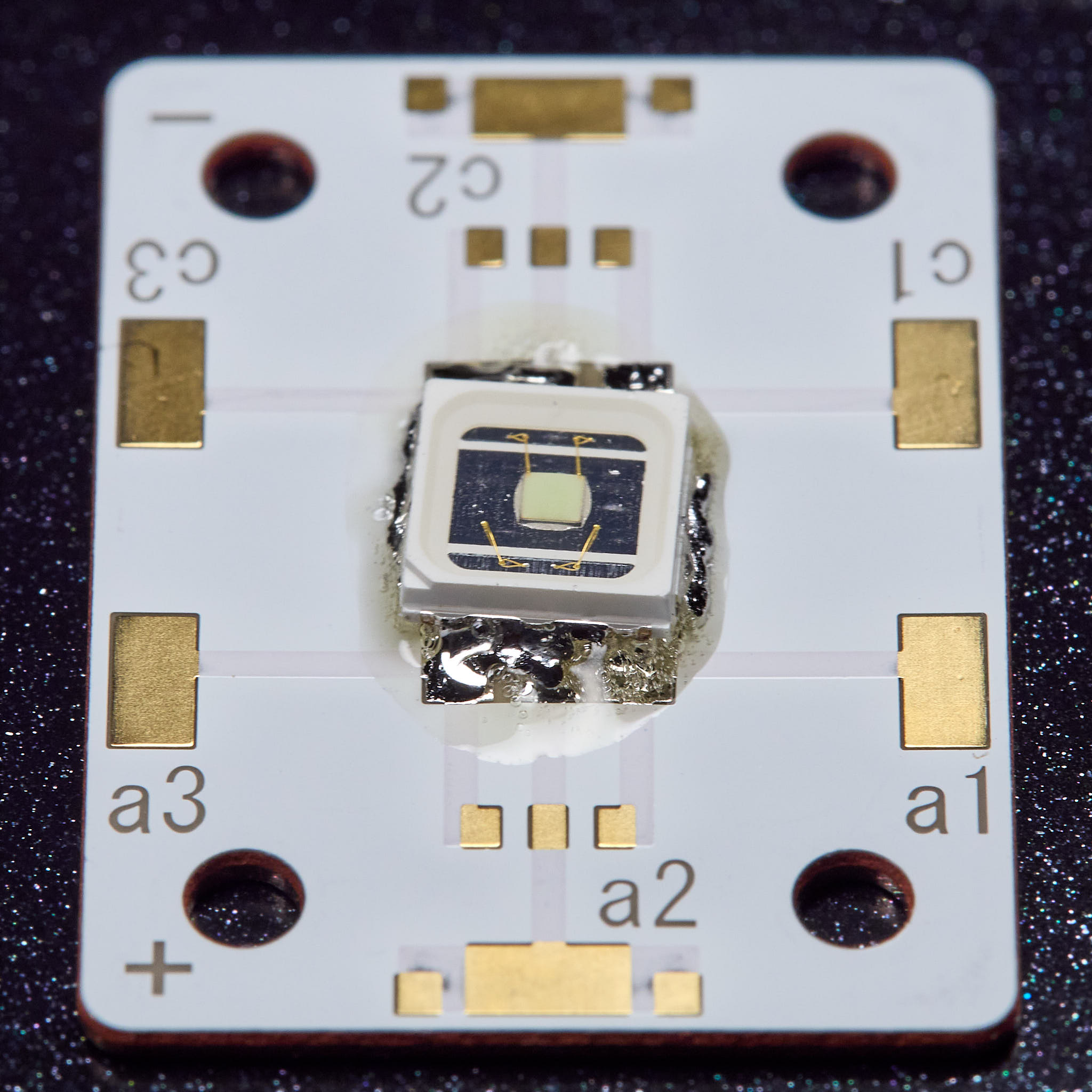 Surface tension pulls the molten metal to the contact pads