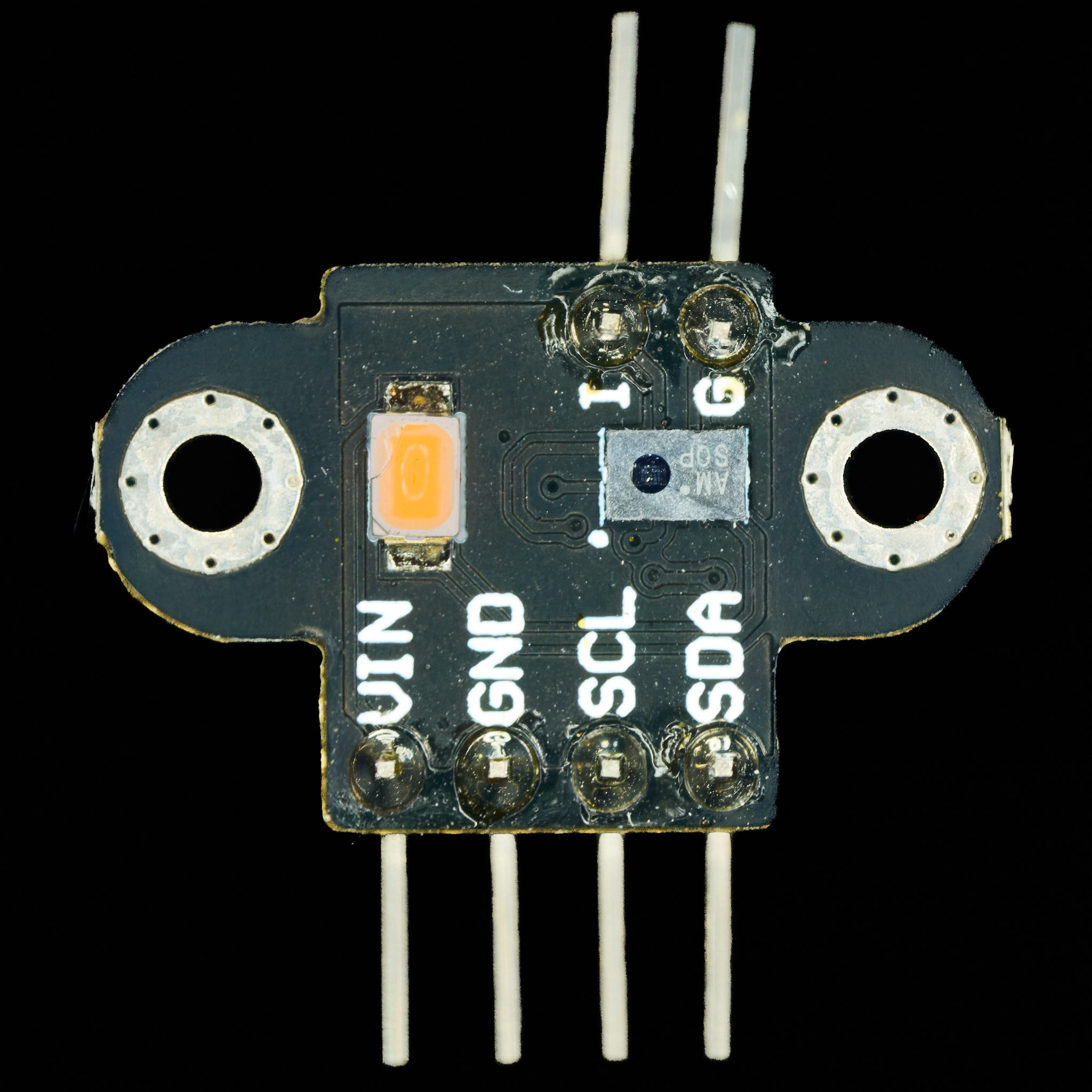 Photograph of sensor in breakout board and a LED